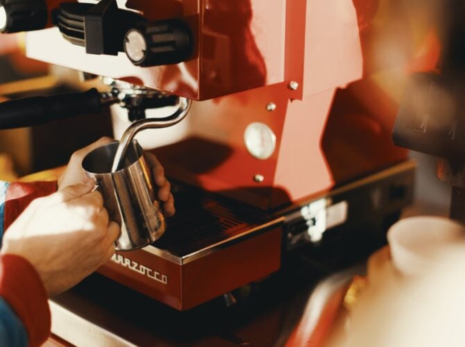 Pulling espresso with La Marzocco Linea Micra in red, detail view of portafilter and group head